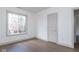 Bedroom features hardwood floors and a window overlooking the exterior at 5537 Broadway St, Indianapolis, IN 46220