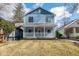 Charming two-story home with a covered front porch, showcasing its inviting curb appeal at 5537 Broadway St, Indianapolis, IN 46220