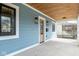 Covered porch featuring wood ceilings and trim, as well as black iron outdoor lighting fixtures at 5537 Broadway St, Indianapolis, IN 46220