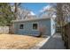 A detached garage with blue siding and a white trim, situated in a well-kept backyard at 5537 Broadway St, Indianapolis, IN 46220