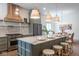 Bright kitchen with light-green cabinets, marble countertops, stainless appliances and a large island at 5537 Broadway St, Indianapolis, IN 46220