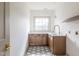 Bright laundry room featuring custom cabinets, marble countertops, and stylish tile flooring at 5537 Broadway St, Indianapolis, IN 46220