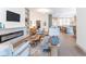 Open-concept living room flows to the kitchen, featuring a fireplace and built-in shelving at 5537 Broadway St, Indianapolis, IN 46220