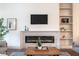 Modern living room featuring a sleek fireplace, built-in shelving, and contemporary decor at 5537 Broadway St, Indianapolis, IN 46220