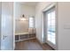 A mudroom featuring a bench, storage, hooks and a door to the outside at 5537 Broadway St, Indianapolis, IN 46220
