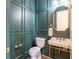 Stylish powder room with green wainscoting, gold accents, and a pedestal sink at 5537 Broadway St, Indianapolis, IN 46220