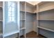 Spacious walk-in closet featuring custom shelving and ample storage space at 5537 Broadway St, Indianapolis, IN 46220