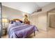 Comfortable bedroom boasts natural light, wood floors, vaulted ceiling, and closet storage space at 5721 Quail Crossing Dr, Indianapolis, IN 46237