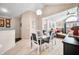 Open concept dining area featuring a glass topped dining table and four chairs at 5721 Quail Crossing Dr, Indianapolis, IN 46237