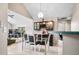 A full view of the dining area shows a glass table, bar area and great natural light at 5721 Quail Crossing Dr, Indianapolis, IN 46237