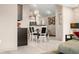 Open-concept dining area with modern lighting and views of the kitchen at 5721 Quail Crossing Dr, Indianapolis, IN 46237