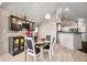 Elegant dining area with modern furnishings, stylish lighting, and a built-in bar at 5721 Quail Crossing Dr, Indianapolis, IN 46237