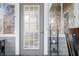Close-up of a gray door with glass panes and gold hardware, offering access to a charming patio at 5721 Quail Crossing Dr, Indianapolis, IN 46237