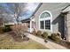 Side view of a charming single-story home with attractive landscaping and an American flag at 5721 Quail Crossing Dr, Indianapolis, IN 46237