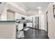 Bright kitchen with stainless steel appliances, white cabinetry, and dark wood flooring at 5721 Quail Crossing Dr, Indianapolis, IN 46237