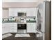Updated kitchen with stainless steel appliances, green countertops, and white cabinets at 5721 Quail Crossing Dr, Indianapolis, IN 46237
