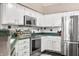 Well-lit kitchen featuring stainless steel appliances and white cabinets with nice countertops at 5721 Quail Crossing Dr, Indianapolis, IN 46237