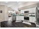 Spacious kitchen with stainless appliances and dark floors opens to the living area at 5721 Quail Crossing Dr, Indianapolis, IN 46237