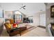 Inviting living room with vaulted ceilings, ceiling fan, and sliding door access at 5721 Quail Crossing Dr, Indianapolis, IN 46237