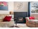 Cozy living room featuring a fireplace, comfortable seating, and a bright window at 5721 Quail Crossing Dr, Indianapolis, IN 46237