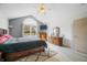 Charming main bedroom with a vaulted ceiling and large window letting in natural light at 5721 Quail Crossing Dr, Indianapolis, IN 46237