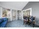 Enclosed patio featuring a seating area, tile floor, a table with chairs, and a view of the outdoors at 5721 Quail Crossing Dr, Indianapolis, IN 46237