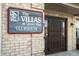 Close-up of the Villas at Quail Run Clubhouse sign with a brick exterior at 5721 Quail Crossing Dr, Indianapolis, IN 46237