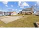 Spacious backyard featuring a concrete slab for play, a cozy fire pit, and well-maintained lawn at 5732 Bold Ruler Dr, Indianapolis, IN 46237