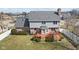Aerial view of the home's back exterior featuring a wooden deck and well maintained yard at 5732 Bold Ruler Dr, Indianapolis, IN 46237