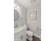 Half bathroom with decorative mirror, marble countertop, and silver faucet at 5732 Bold Ruler Dr, Indianapolis, IN 46237