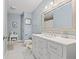 Well-lit bathroom with white vanity, marble floors, modern fixtures, and ample counter space at 5732 Bold Ruler Dr, Indianapolis, IN 46237