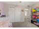 Bright bedroom with a closet, a dresser, an open doorway, and shelving units at 5732 Bold Ruler Dr, Indianapolis, IN 46237