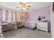 Charming bedroom with soft purple walls, a desk, a comfy bed, and cheerful decor at 5732 Bold Ruler Dr, Indianapolis, IN 46237