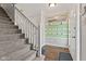 Inviting entryway featuring a staircase, coat rack, and decorative mirror at 5732 Bold Ruler Dr, Indianapolis, IN 46237