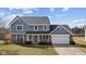 Charming two-story home with a well-manicured lawn, a brick facade, and a welcoming front porch at 5732 Bold Ruler Dr, Indianapolis, IN 46237