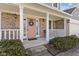 Inviting front porch with brick columns, a pink front door, and a 'Welcome' mat at 5732 Bold Ruler Dr, Indianapolis, IN 46237