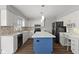 Modern kitchen featuring white cabinets, a blue island, and stainless steel appliances at 5732 Bold Ruler Dr, Indianapolis, IN 46237