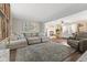 Inviting living room with a fireplace, large sofa, and hardwood floors at 5732 Bold Ruler Dr, Indianapolis, IN 46237