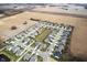 Aerial community view showcasing well-maintained homes, green spaces, and a serene pond at 602 Tuscany Trl, Lapel, IN 46051