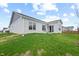 A backyard featuring a lush lawn, patio, and nearby homes at 602 Tuscany Trl, Lapel, IN 46051