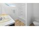 Bright bathroom with a white vanity, a tub and shower combination, and neutral vinyl flooring at 602 Tuscany Trl, Lapel, IN 46051