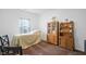 Well-lit bedroom with wooden furnishings, neutral walls, and a view of the outside from the window at 602 Tuscany Trl, Lapel, IN 46051