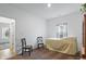 Bright bedroom with two chairs, neutral walls, and a view of the outside from the window at 602 Tuscany Trl, Lapel, IN 46051