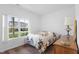 Bright bedroom with large window showing neighborhood view and patterned bedspread at 602 Tuscany Trl, Lapel, IN 46051