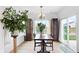 Dining room with a chandelier, slider to the outside, large plant, and two large cabinets at 602 Tuscany Trl, Lapel, IN 46051