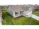 A cozy home featuring manicured lawn and landscaping, complemented by a quaint front porch with seating at 602 Tuscany Trl, Lapel, IN 46051