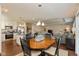 Open concept kitchen, living, and dining area with hardwood floors and stainless steel appliances at 6400 Woodland Ln, McCordsville, IN 46055