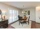 Cozy dining area with hardwood floors, stylish lighting, and sliding doors for ample natural light at 6400 Woodland Ln, McCordsville, IN 46055