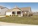Charming brick home featuring a manicured front yard, attached garage, and covered entry way at 6400 Woodland Ln, McCordsville, IN 46055