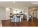 Bright kitchen featuring stainless appliances, granite counters, and an island with bar seating at 6400 Woodland Ln, McCordsville, IN 46055